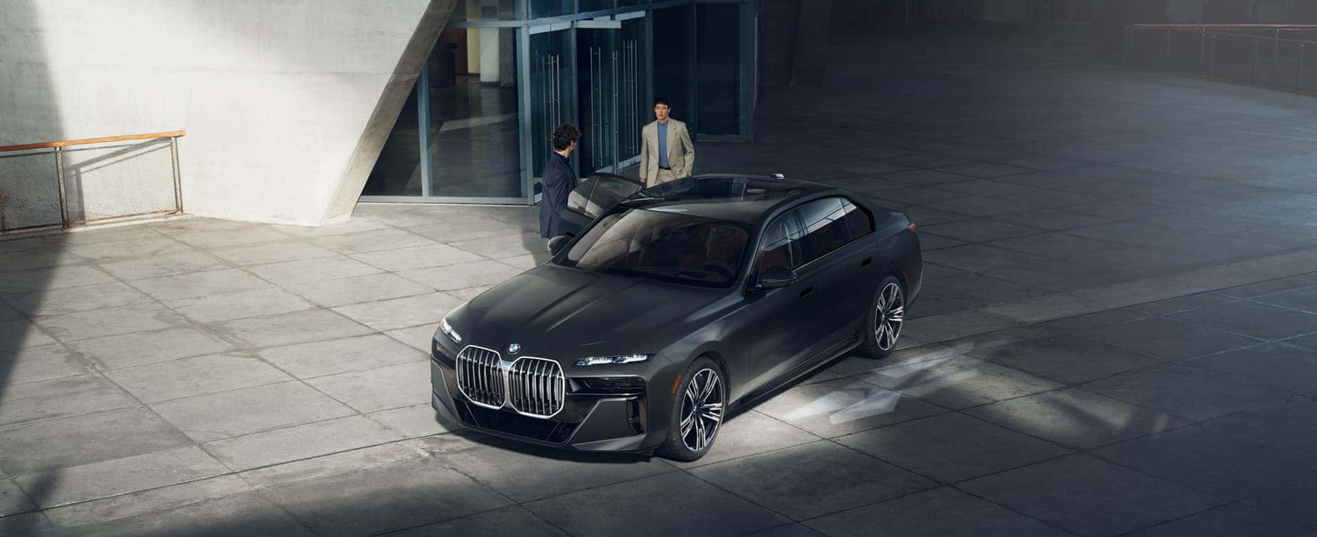 Overhead shot of two people standing by BMW 7 Series