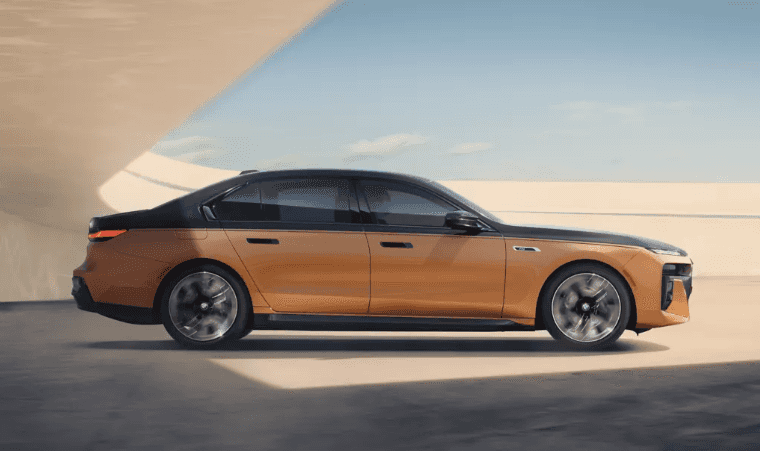 Two-tone BMW i7 sedan parked in a modern open-air structure near BMW of Northwest Arkansas.