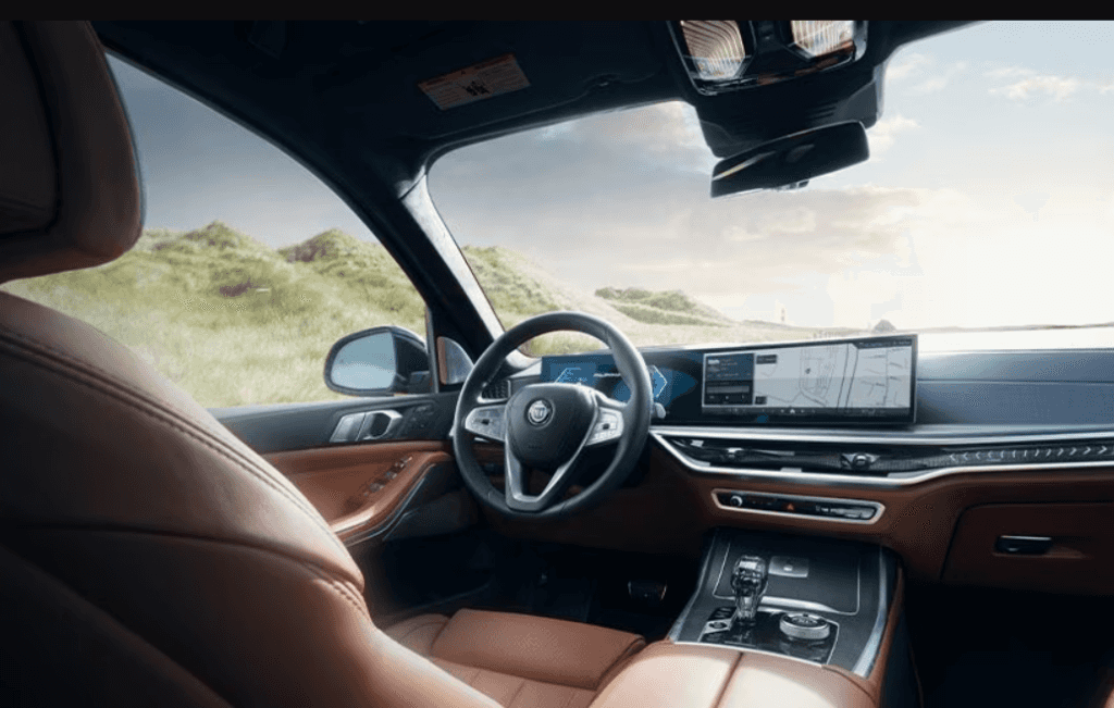 Interior of the BMW Alpina XB7 showcasing a digital cockpit and brown leather seating.