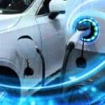 EV Car or Electric vehicle at charging station with the power cable supply plugged in on blurred nature with blue energy power effect. Eco-friendly sustainable energy concept.
