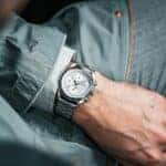 Man looking at expensive watch on his wrist