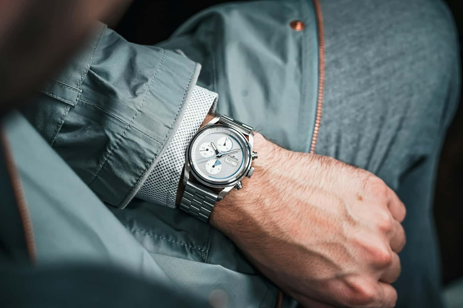 Man looking at expensive watch on his wrist