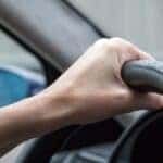 Hand on steering wheel