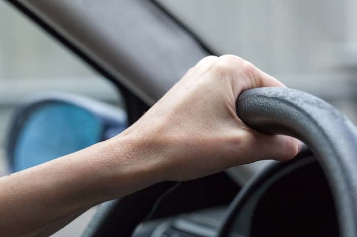 Hand on steering wheel