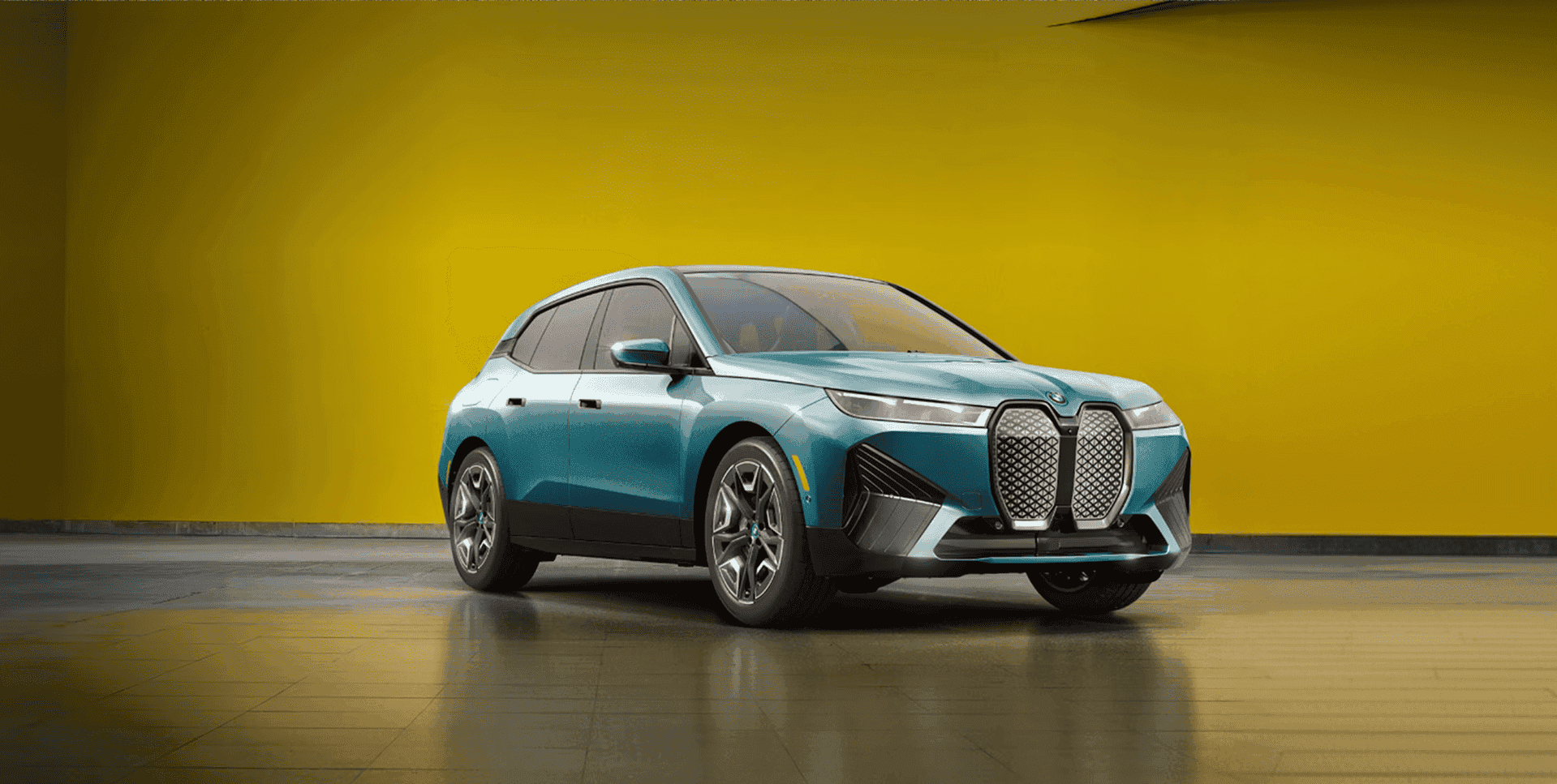 BMW iX electric SUV on yellow background