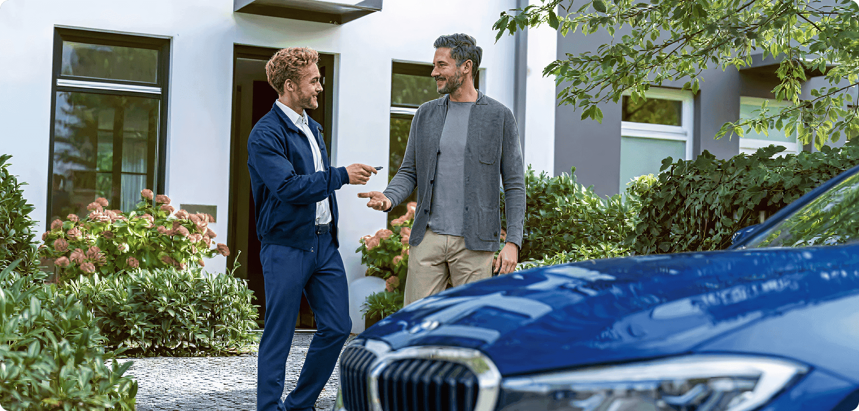 BMW dealership representative hands keys to customer