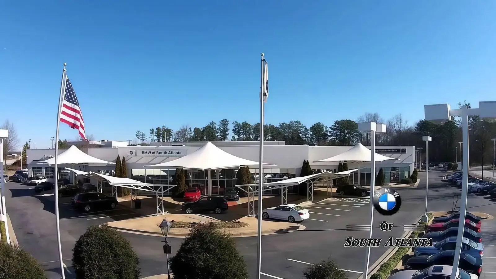BMW of South Atlanta dealership at 4171 Jonesboro Rd, Union City, GA — front entry, BMW signage, customer-parking canopies, and the Hank Aaron lot since 1999.