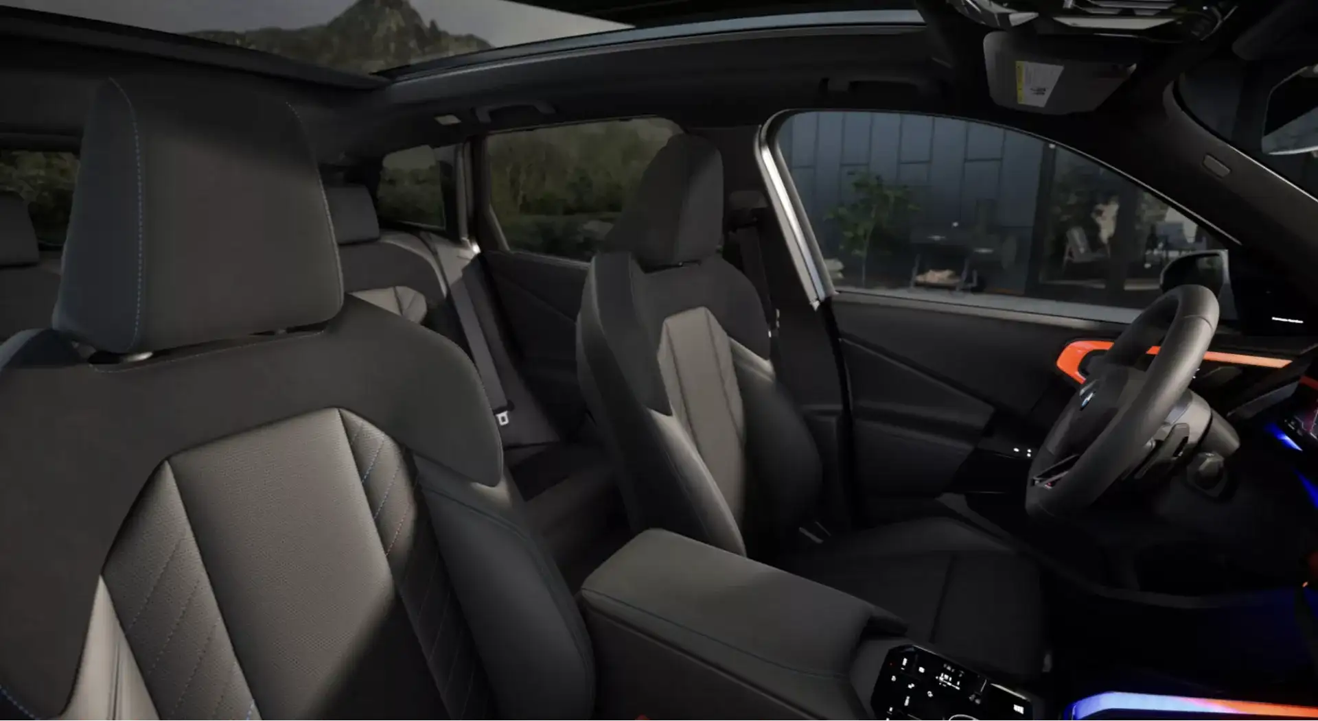 BMW interior with black leather seats, panoramic moonroof, and curved digital display