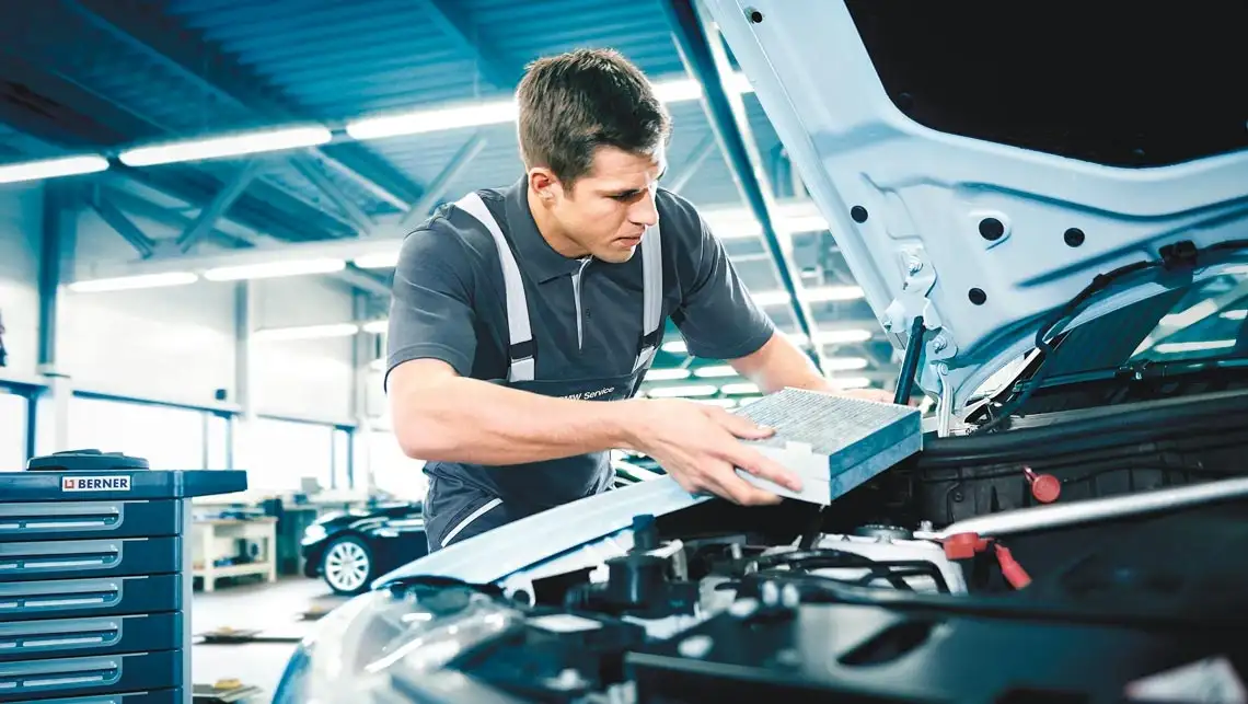 BMW service technician performing a multi-point brake inspection at BMW of South Atlanta