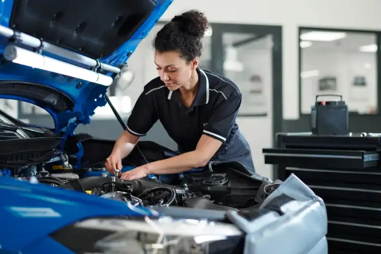 BMW-certified service technician working under the hood at the BMW of South Atlanta service drive in Union City, GA