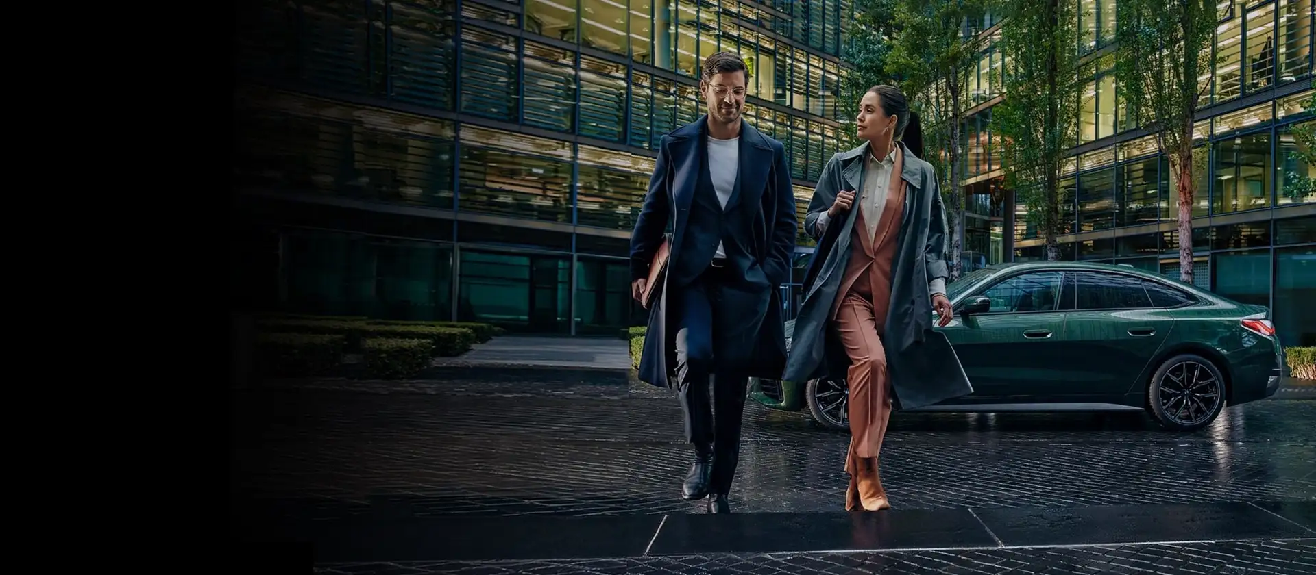 Two BMW owners walking from their BMW outside a downtown office — BMW Financial Services at BMW of South Atlanta in Union City, GA