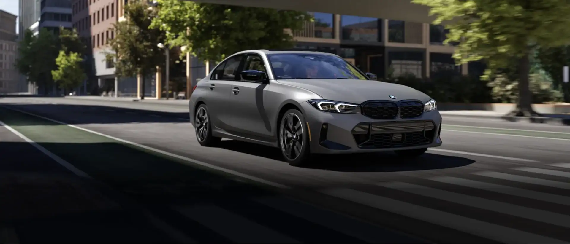 BMW 3 Series sedan driving through a city street, eligible for BMW finance specials and lease deals at BMW of South Atlanta.