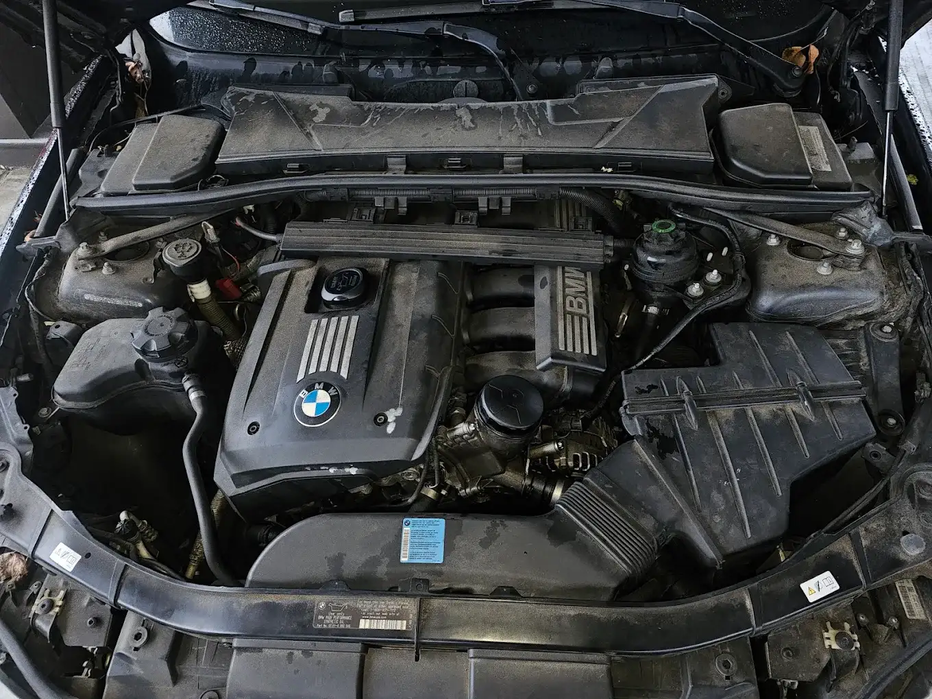 A BMW inline-six engine bay open on the service drive at BMW of South Atlanta
