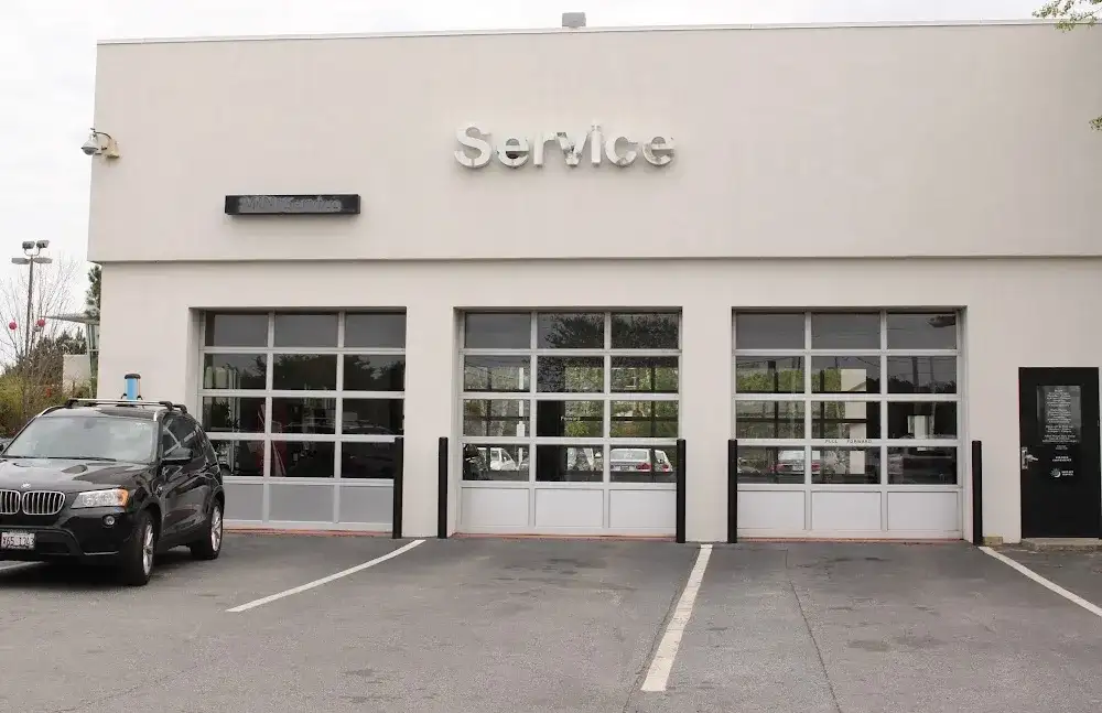The Service entrance at BMW of South Atlanta — three glass bay doors under the Service sign, a BMW X3 parked out front