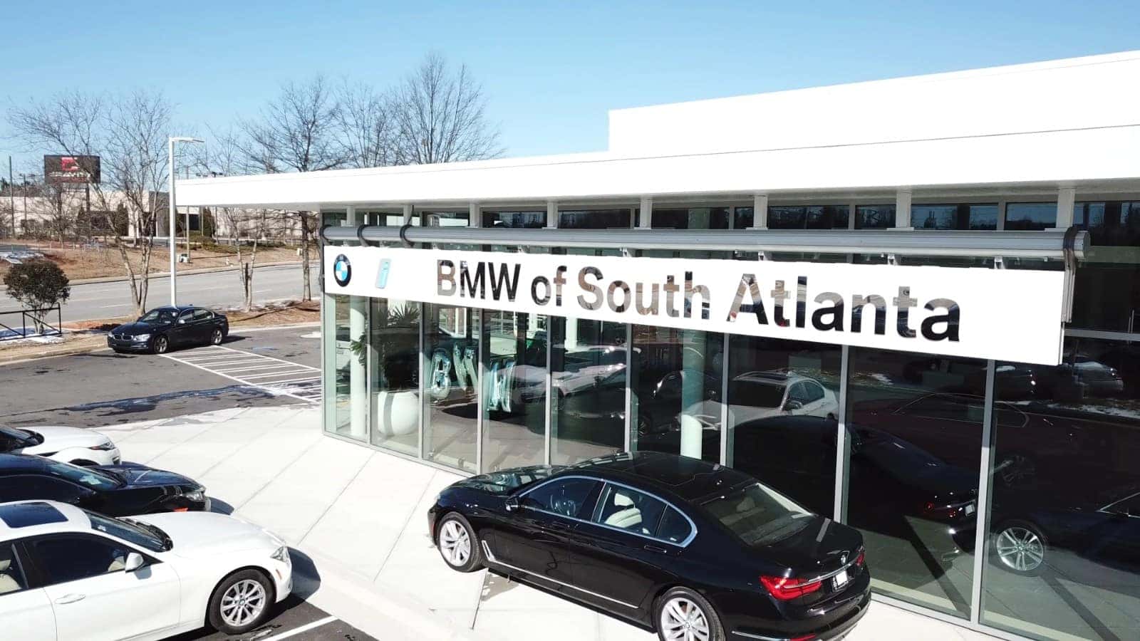 BMW of South Atlanta storefront in Union City, GA — the glass showroom with BMW of South Atlanta signage and BMW 7 Series and 3 Series inventory out front