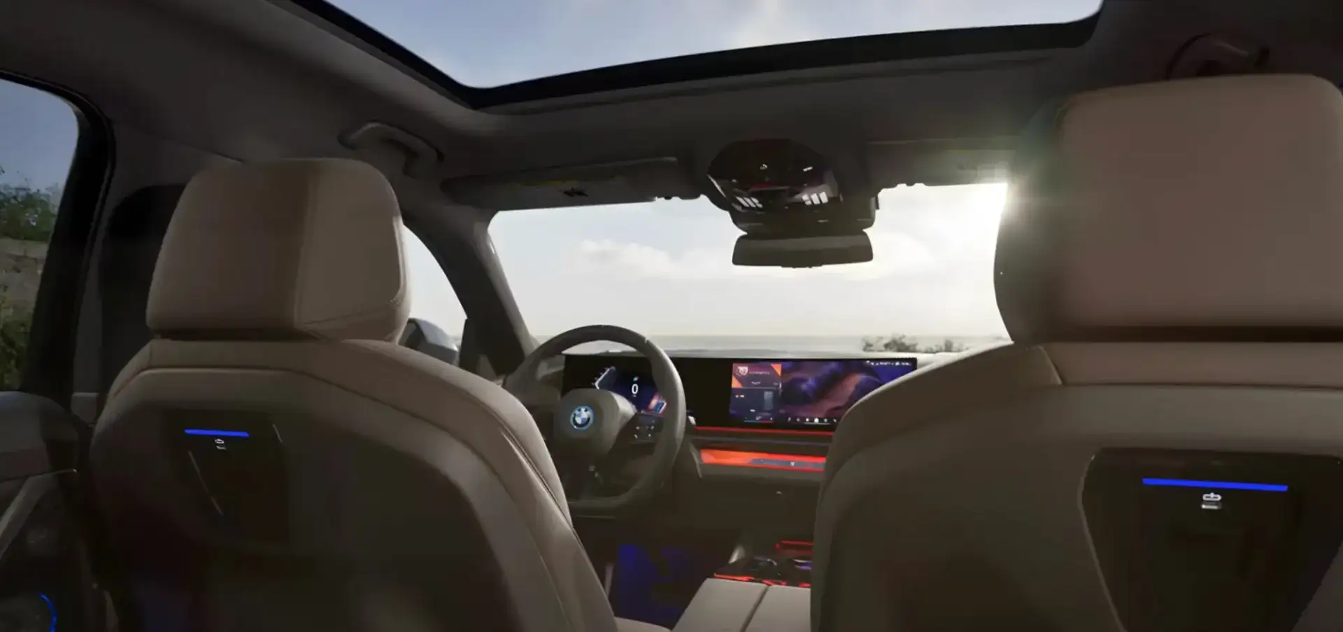 Front view of the BMW i5 with illuminated grille and headlights