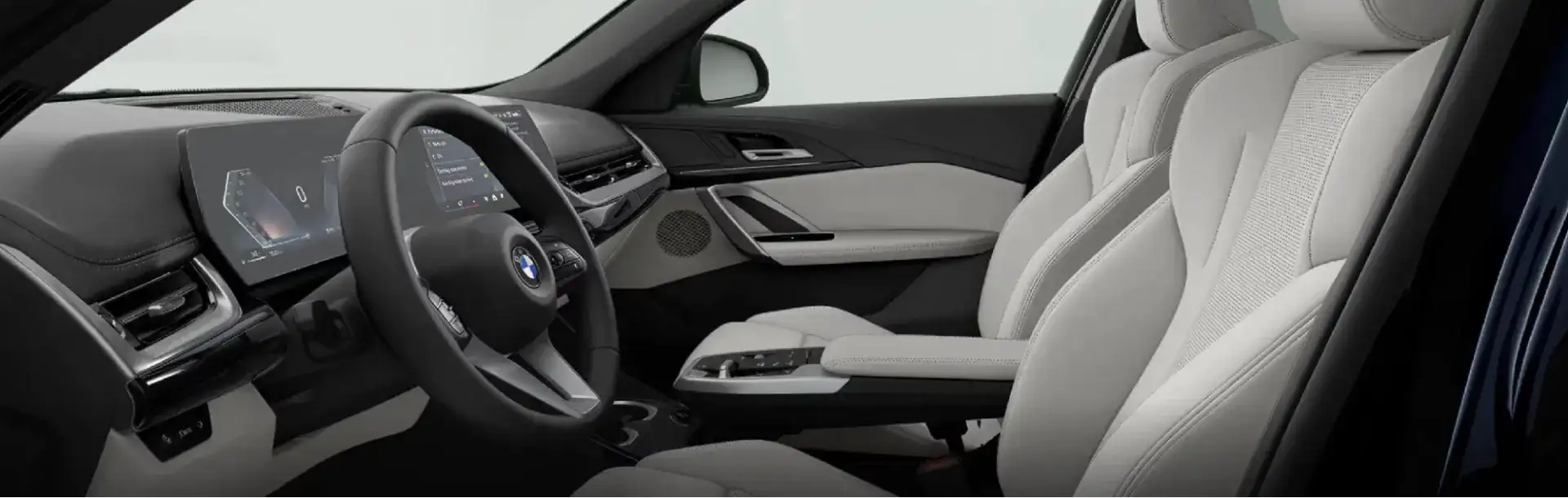 Front cabin of the 2026 BMW X1 with light gray seats and the BMW Curved Display