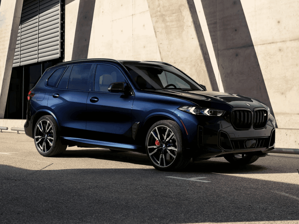BMW X5 driving a mountain pass at golden hour, the kind of miles BMW Ultimate Care covers in its first three years