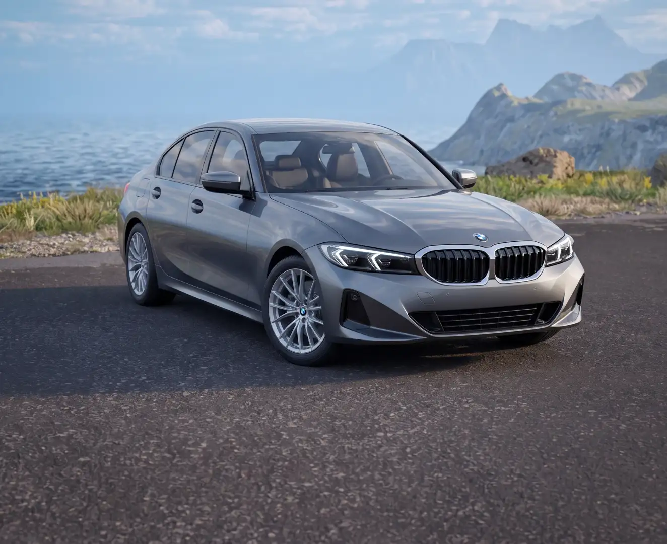A gray BMW 330i on a coastal road with mountains behind it