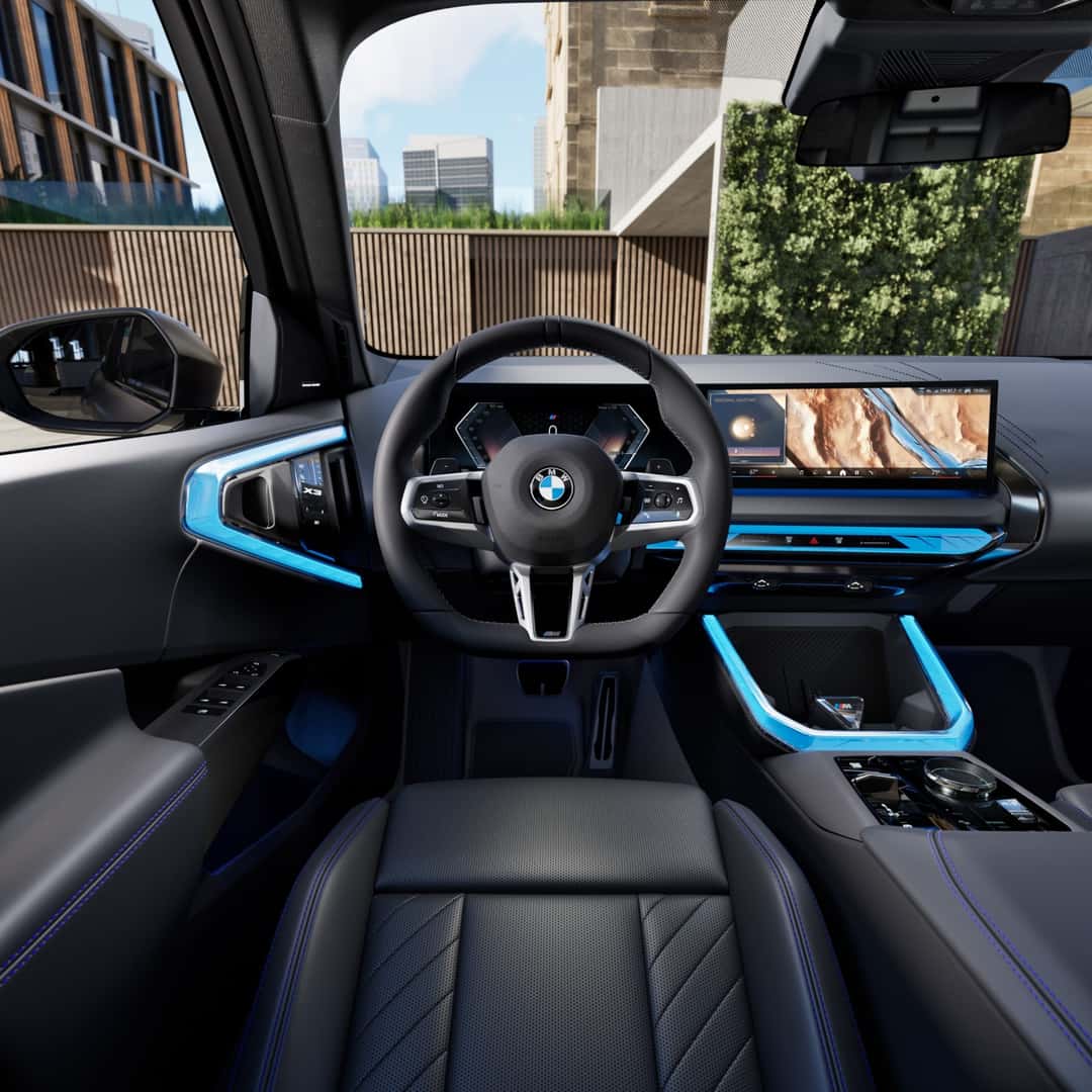 2026 BMW X3 cockpit in daylight with the curved display, where the Condition Based Service system reports when oil service is due