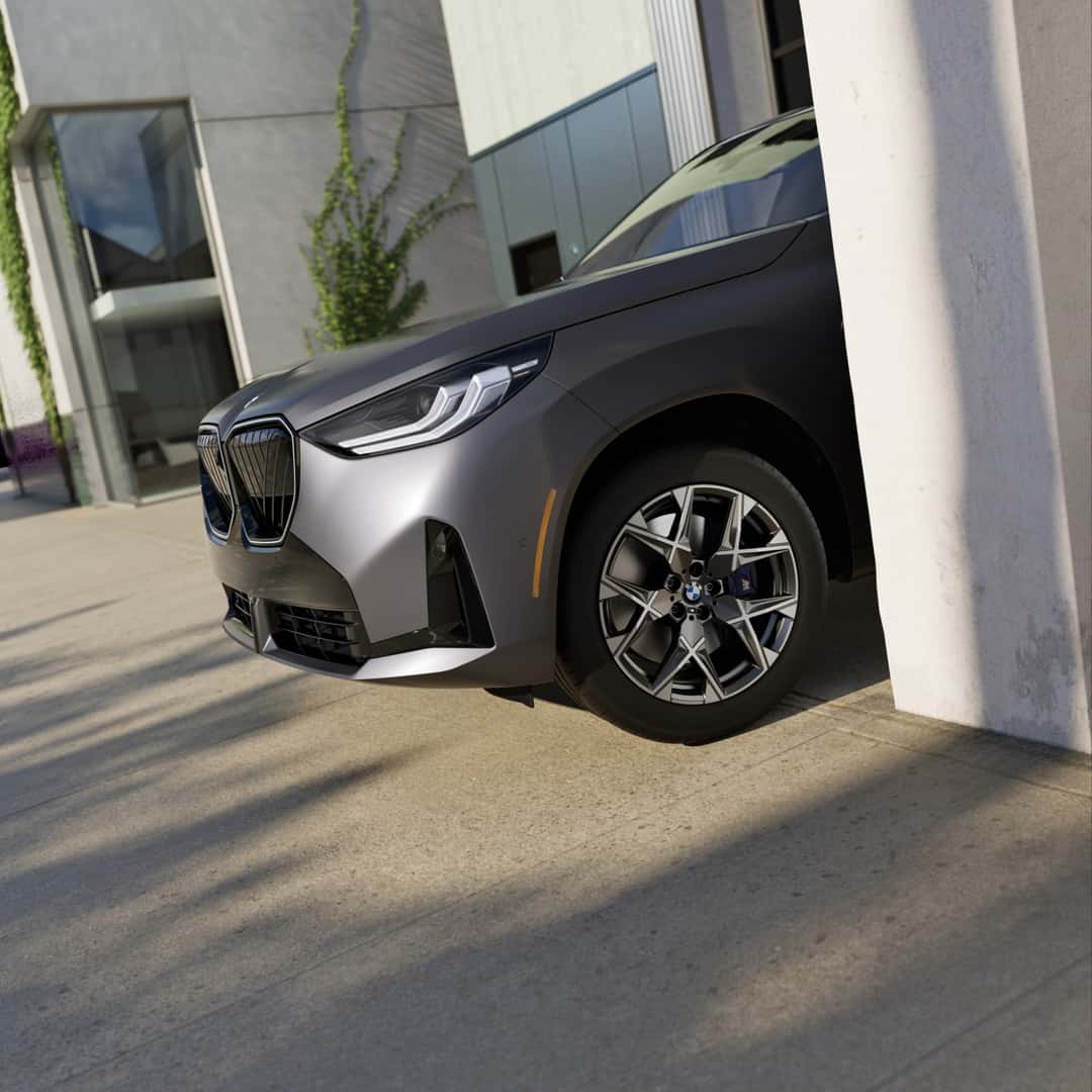 2026 BMW X3 front quarter in bright morning light, wheel and brake caliper in view — the components measured during the multi-point inspection