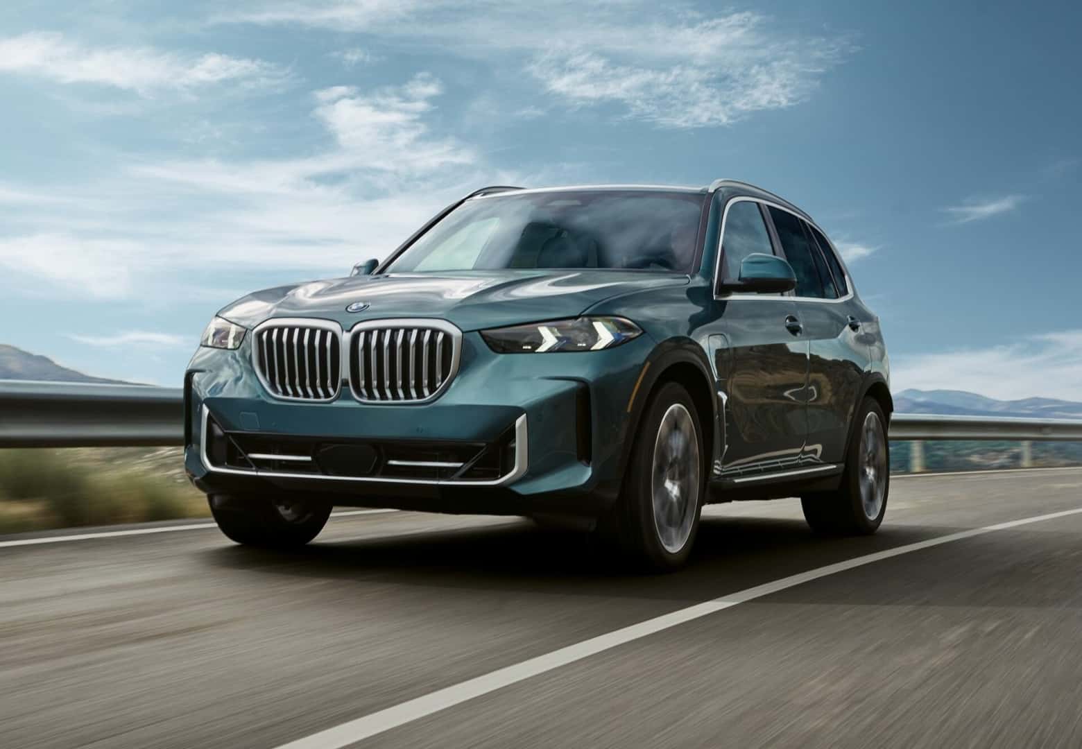 BMW X5 cruising a bright mountain highway, one of the models aligned to factory targets at BMW of South Atlanta