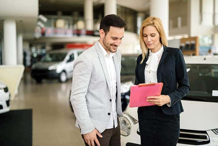 when to trade in your vehicle at Boch Automotive in Massachusetts | Sales person showing client information when to trade in your vehicle at Boch Automotive in Massachusetts | Sales person showing client information