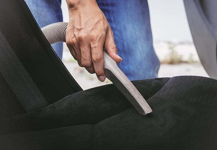 Where do I begin the process of trading in a vehicle at Boch Automotive of Massachusetts | Man Vacuuming car seat Where do I begin the process of trading in a vehicle at Boch Automotive of Massachusetts | Man Vacuuming car seat