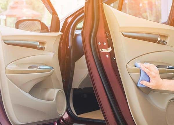 Where do I begin the process of trading in a vehicle at Boch Automotive of Massachusetts | Man wiping the interior of the car Where do I begin the process of trading in a vehicle at Boch Automotive of Massachusetts | Man wiping the interior of the car