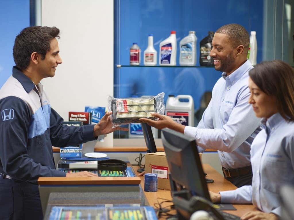 3 Main Benefits of Using OEM parts for your vehicle at Boch of Massachusetts | Man buying OEM honda filter