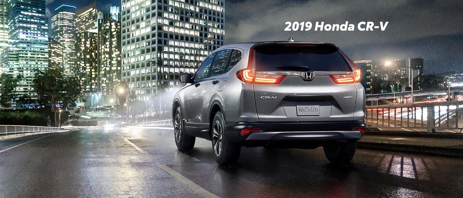Comparison of the 2019 Pilot versus 2019 CR-V at Boch Honda of Norwood | Sliver 2019 Honda CR-V parked on street at night Comparison of the 2019 Pilot versus 2019 CR-V at Boch Honda of Norwood | Sliver 2019 Honda CR-V parked on street at night