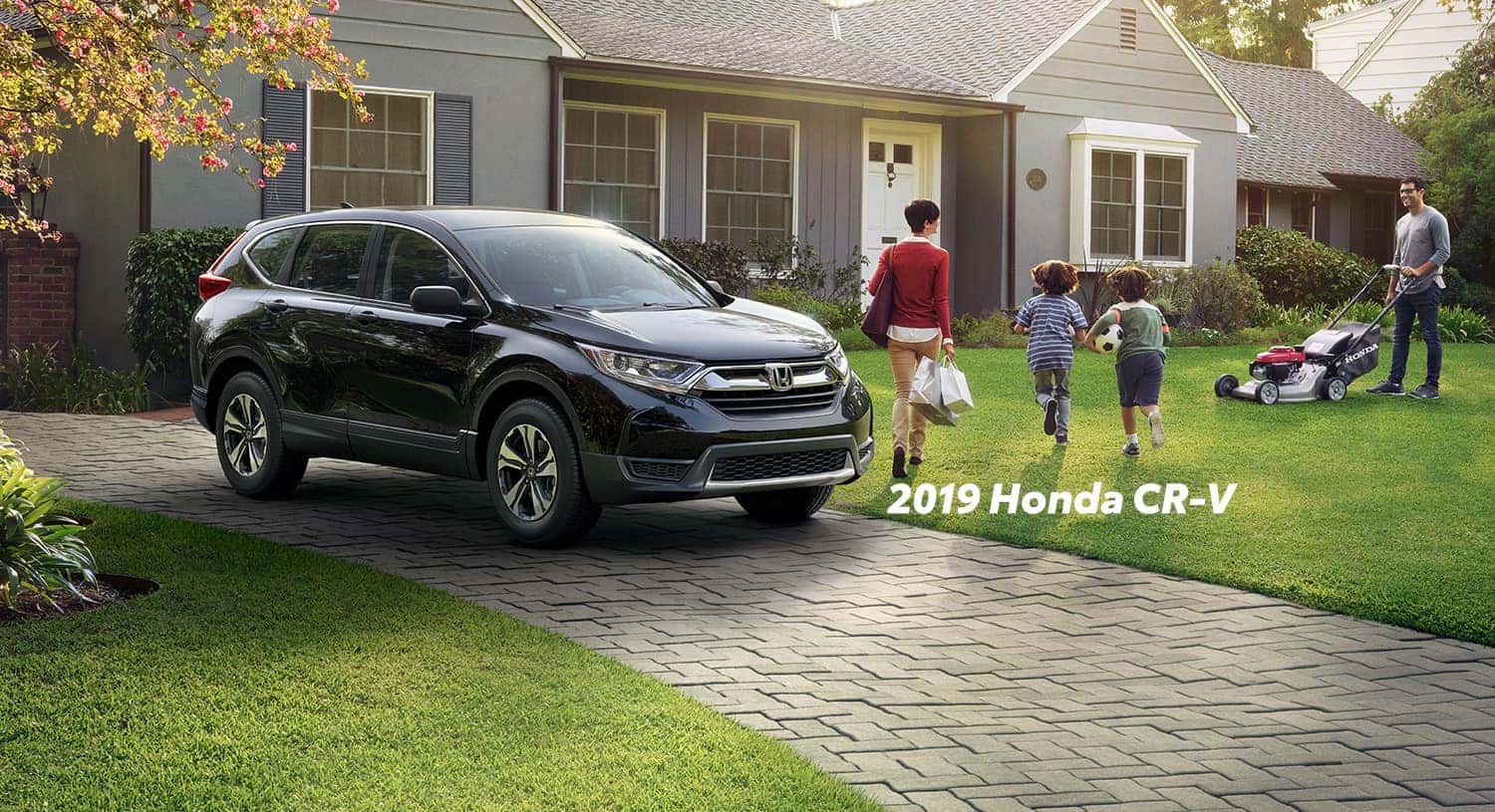 Comparison of the 2019 Pilot versus 2019 CR-V at Boch Honda of Norwood | The 2019 Honda CR-V parked in a drive way Comparison of the 2019 Pilot versus 2019 CR-V at Boch Honda of Norwood | The 2019 Honda CR-V parked in a drive way