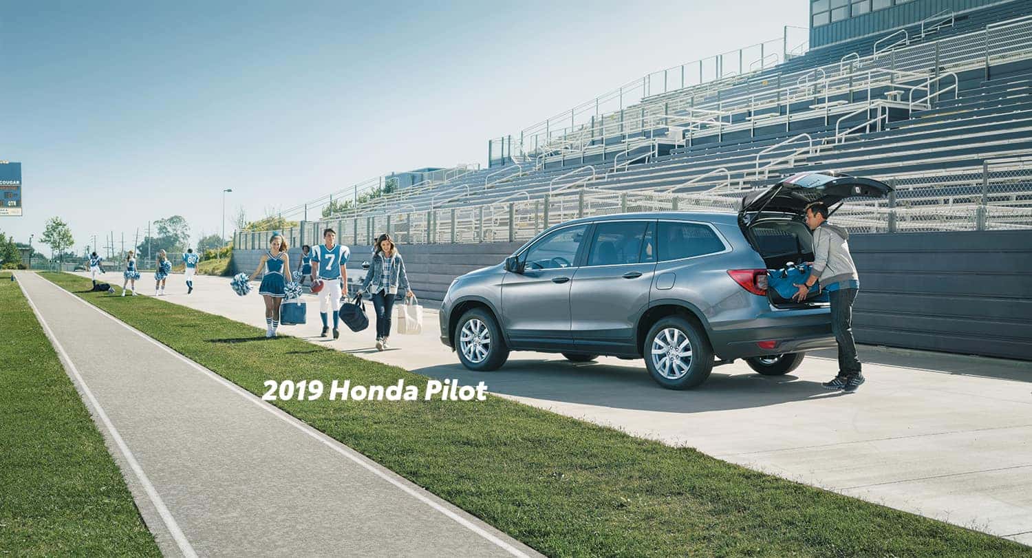 Comparison of the 2019 Pilot versus 2019 CR-V at Boch Honda of Norwood | 2019 Honda Pilot parked infront of a football field Comparison of the 2019 Pilot versus 2019 CR-V at Boch Honda of Norwood | 2019 Honda Pilot parked infront of a football field