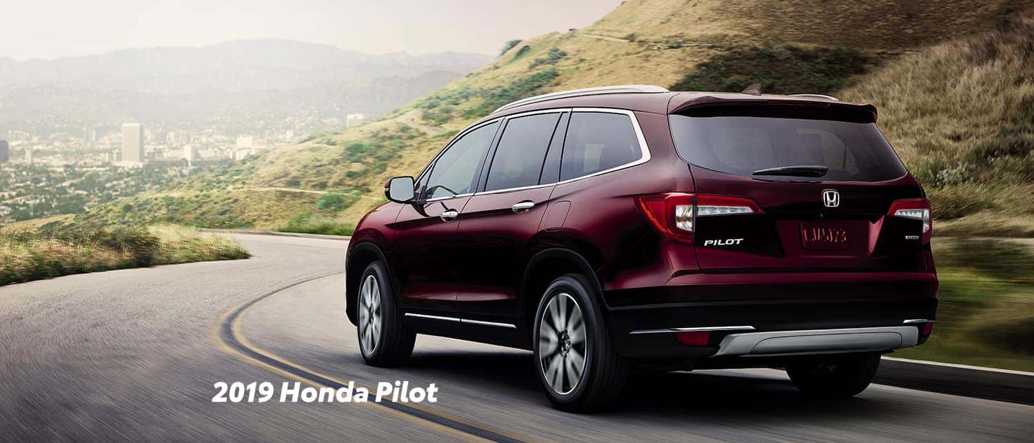 Comparison of the 2019 Pilot versus 2019 CR-V at Boch Honda of Norwood | Red 2019 Honda Pilot running on road Comparison of the 2019 Pilot versus 2019 CR-V at Boch Honda of Norwood | Red 2019 Honda Pilot running on road
