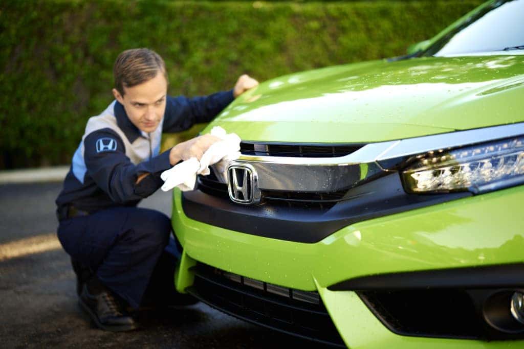 What you can get to personalize your vehicle at Boch Honda in Norwood | Honda technicians cleaning a honda