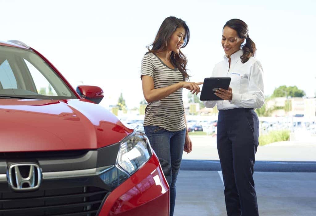 What you can get to personalize your vehicle at Boch Honda in Norwood | Honda agent showing woman car information