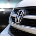 Close up shot of a white Honda grill and logo.
