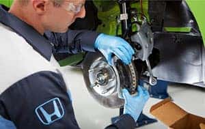 technician fixing brakes