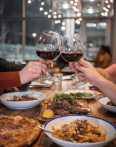 cheering wine glass at dinner