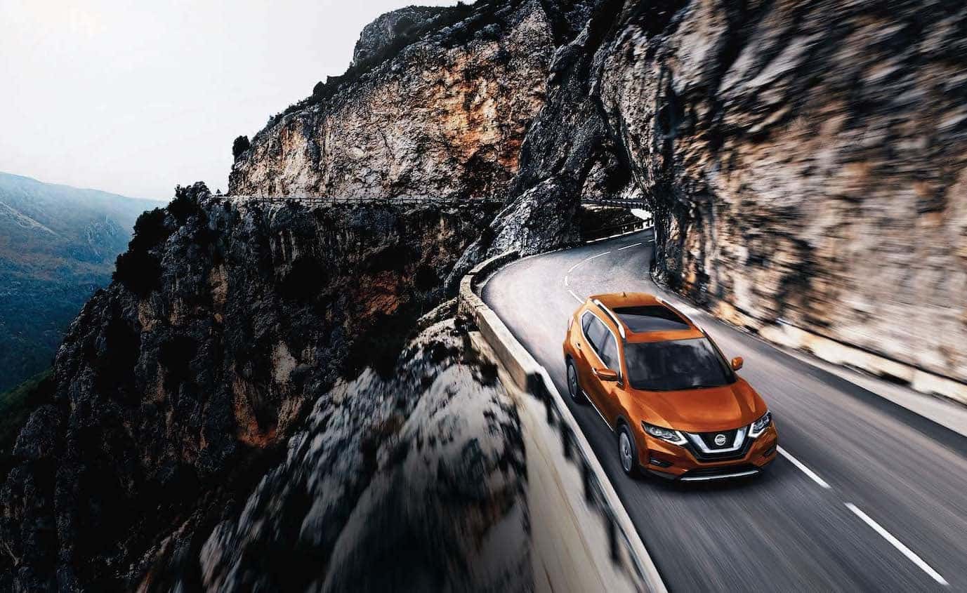 The 2020 Rogue model features at Boch Nissan South in North Attleboro | white 2020 rogue driving up the mountain