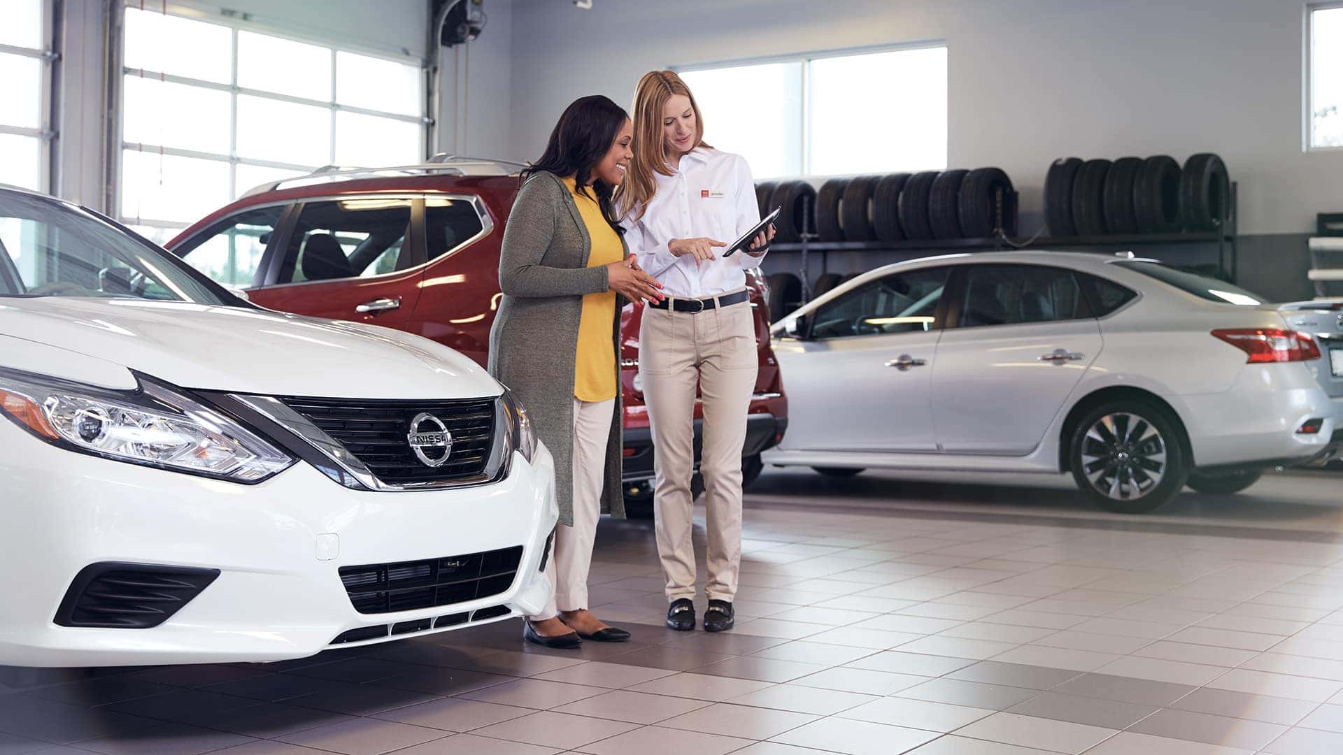 Boch Nissan South is a Family Owned Dealership near Attleboro, MA | Nissan associate helping a customer