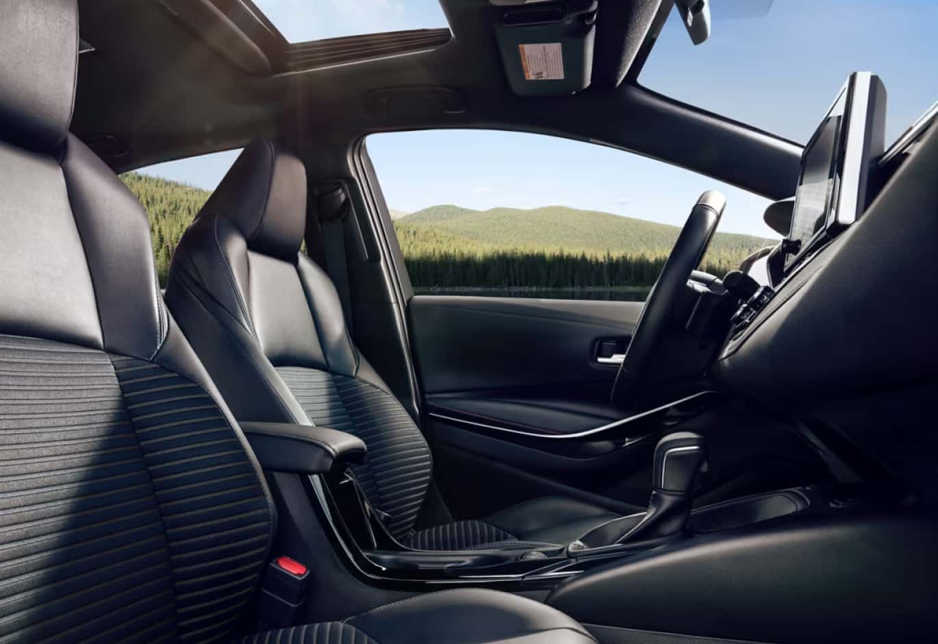 Honda Civic interior passenger view of the drivers seat, steering wheel, and gearshift