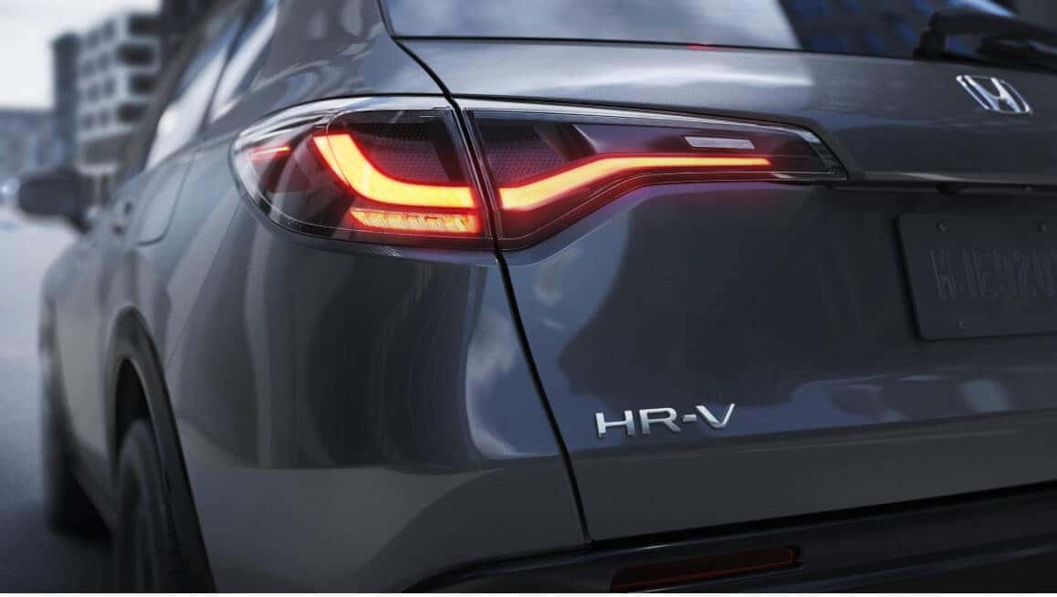 Honda HR-V LX highlighting its illuminated LED taillight along a city street.