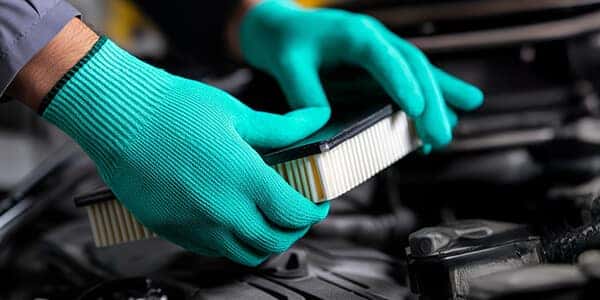 mechanic installing air filter
