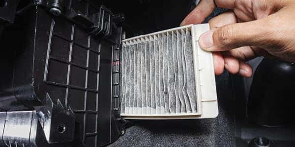 mechanic installing air filter