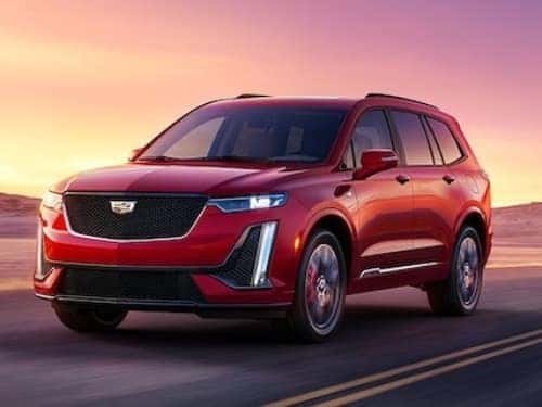 2024 Cadillac XT6 driving on a road at sunset
