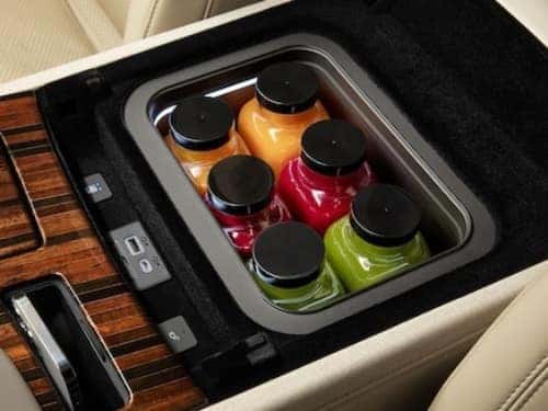 2024 Cadillac Escalade view of center console with refrigerator filled with drinks