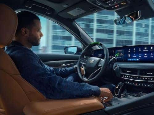 2024 Cadillac CT5 view of man in driver seat with hands off wheel while car is in super cruise mode
