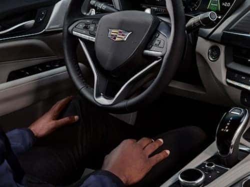 2025 Cadillac CT4 view of man in driver seat with hands on lap while vehicle is in super cruise