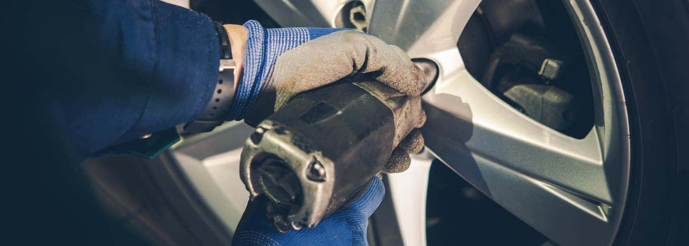 mechanic changing tire zoomed in